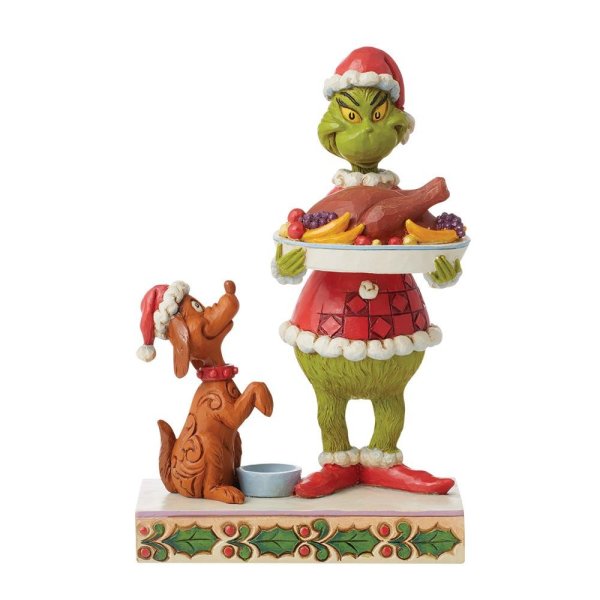 Grinch con la statuina della cena di Natale