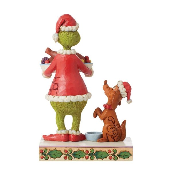 Grinch con la statuina della cena di Natale